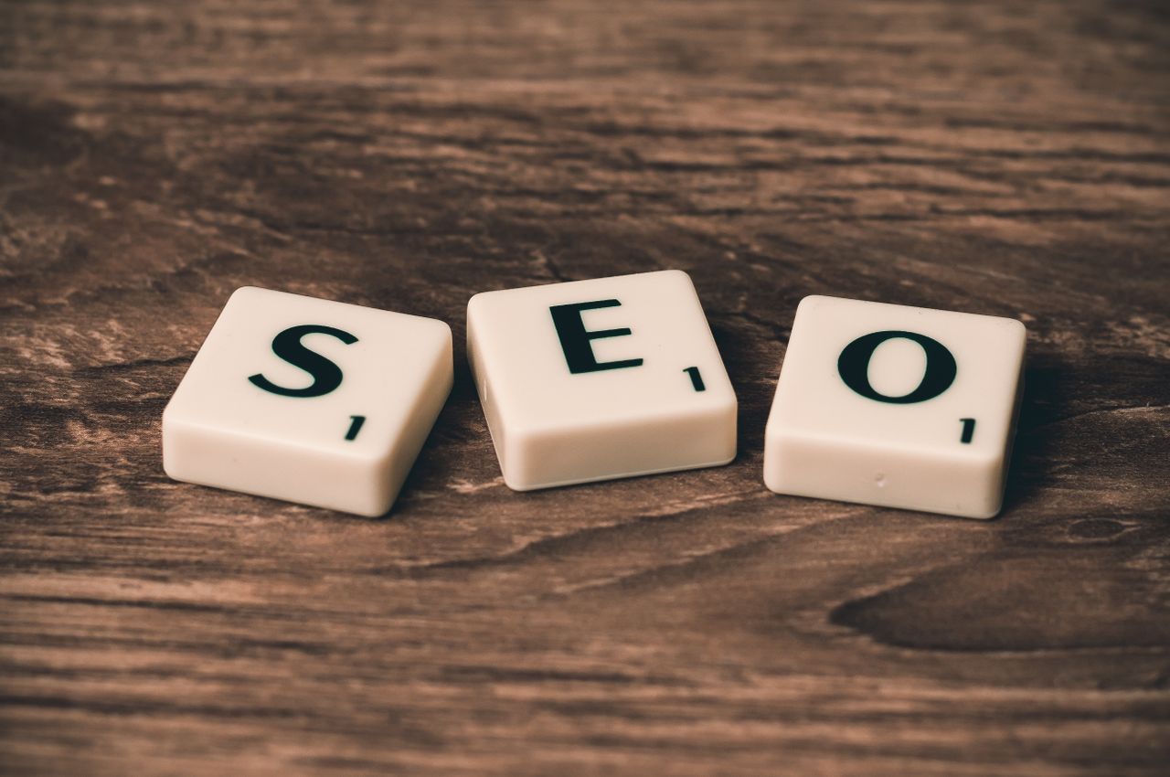 Scrabble tiles arranged to spell SEO on a wooden surface, making it perfect for digital marketing themes.